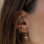 Brinco Estrela do Mar Laguna Pérola - Ouro 18K | SILLENE - uso
