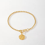 Detalhe da Pulseira Moeda Globo - Ouro 18K | SILLENE