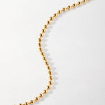 Pulseira Moeda Globo - Ouro 18K em uso | SILLENE