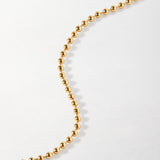 Pulseira Moeda Globo - Ouro 18K em uso | SILLENE